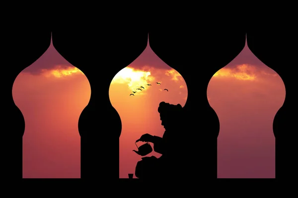 Islamic man makes tea at sunset