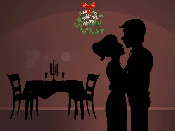 man and woman kissing under the mistletoe