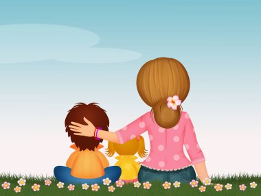 Anne ve çocuklar çimlerin üzerinde oturuyorlar.