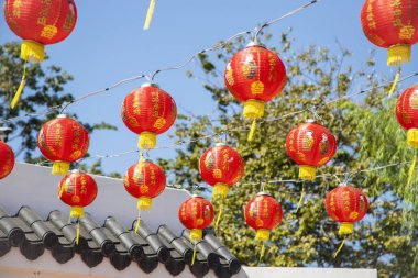 a collapsible paper lantern in bright colours, primarily red, used for decorative purposes, commonly painted with Chinese art. clipart