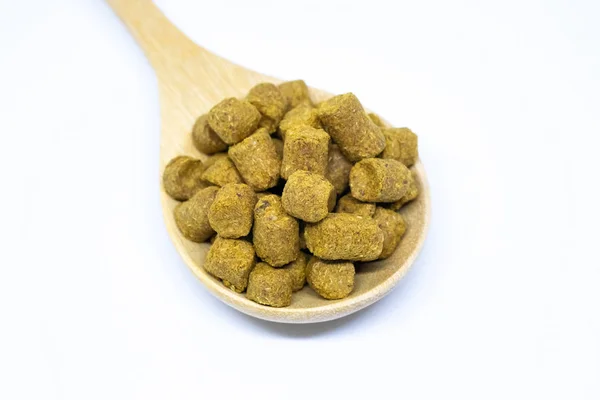 Pellet ev bira izole için bir kaşık ahşap hops.