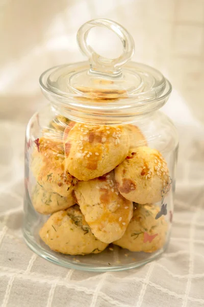 Delicious homemade cookies in jar on cloth surface  close up low angle view