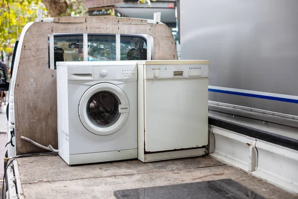 Old discarted dishwasher and washing machine on a vehicle truck   for recycling