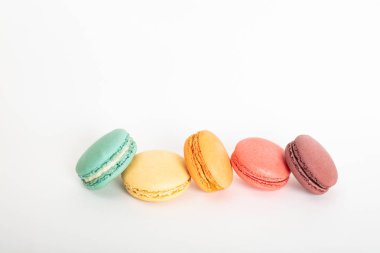 Renkli macarons kek. Küçük Fransız kek. Tatlı ve beyaz arka planda, yüksek açılı görünüş kopya alanı ile renkli Fransızca macaroons