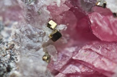 Pink crystals Rhodochrosite with particles of Pyrite. Natural  texture of mineral for background. Beautiful background and wallpaper. Macro clipart