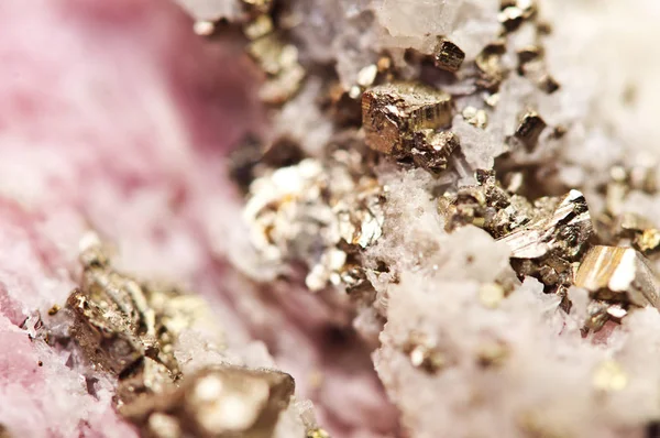 Pink crystals Rhodochrosite with particles of Pyrite. Natural  texture of mineral for background. Beautiful background and wallpaper. Macro