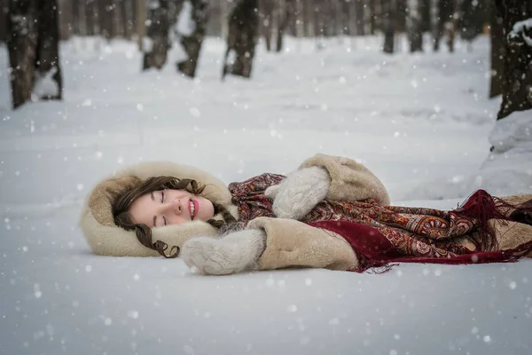 幸せな女の子嘘周り柔らかい雪で冬の日 降雪を歓喜 — ストック写真