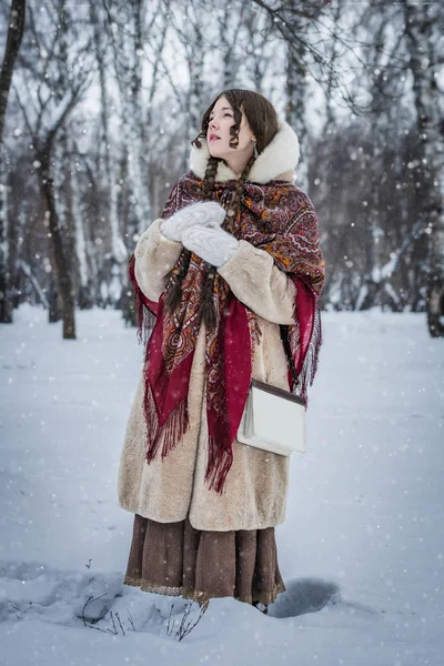 雪に覆われた公園の木 々の間で良い気分寒い冬の日の屋外での女の子 — ストック写真