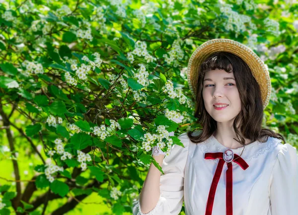 Mujer alegre en vestido blanco cerca del espino en flor — Foto de Stock