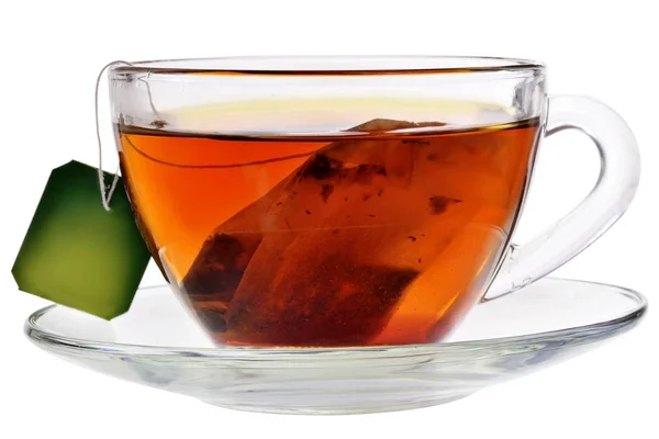 Glass cup with a bag of black tea isolated — Stock Photo, Image