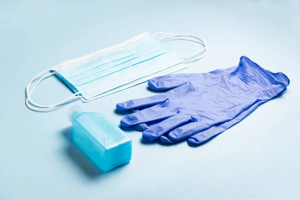 Personal Protective Equipment for CORONAVIRUS: hydroalcoholic gel, medical mask and latex gloves. Coronavirus protection concept (COVID19). Health and medical concept.