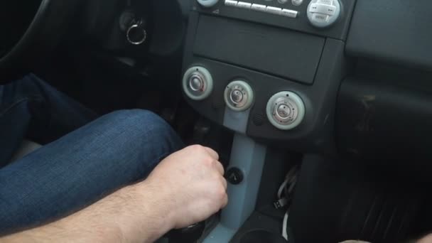 Uma mão de homem muda de velocidades em um carro . — Vídeo de Stock