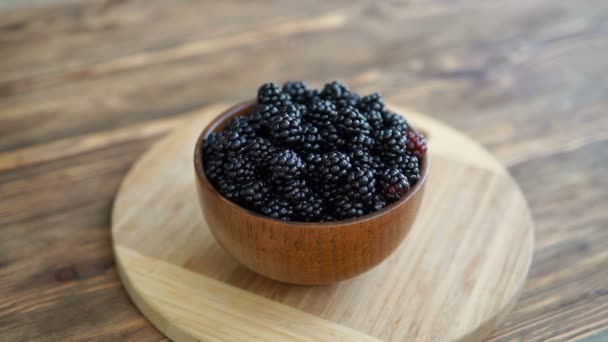 Woman Hand Takesa Bowl Blackberries Wooden Table — Stock Video