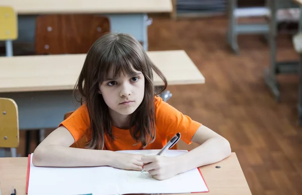 Kleines Mädchen Schreibt Etwas Ins Textbuch Und Sitzt Tisch — Stockfoto