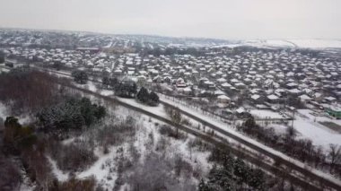 Gökyüzü insansız hava aracıyla cennet kışı manzarası. Kuşların gözünden doğaya doğru koşan bir sokak..