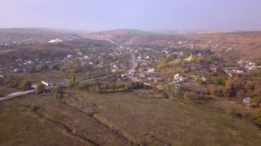 Kamera, Moldova Cumhuriyeti 'ndeki Ortodoks Kilisesi ve küçük bir köy üzerinde uçuyor..