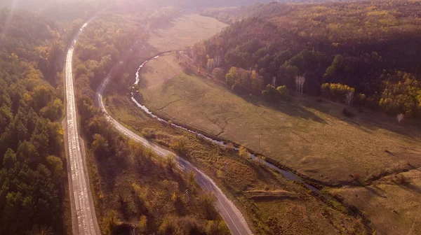 stock image Aerial view of the road through fall forest