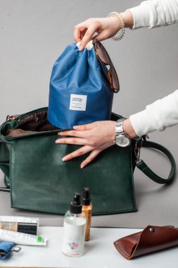 kadın kozmetik çantası koyar