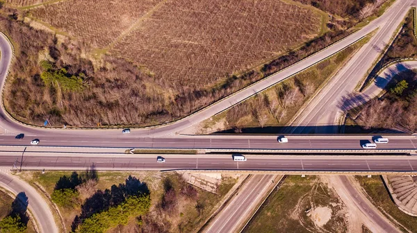 Aerial top down view of interchange road junction traffic.