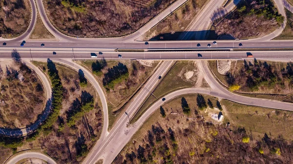 Aerial top down view of interchange road junction traffic.