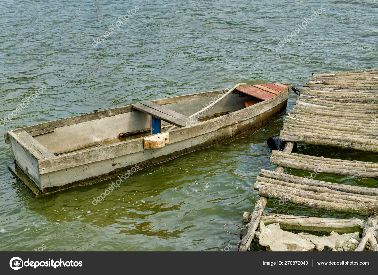 Old Wooden Rowing Fishing Boat Moored Near Lake Or River Coast In