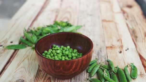 Closeup Woman Hand Depod Green Peas Brown Dish Wooden Table — Stock Video