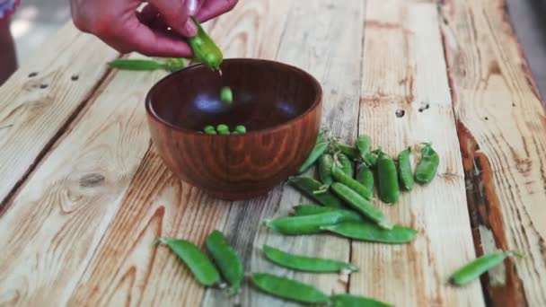 Closeup Woman Hand Depod Green Peas Brown Dish Wooden Table — Stock Video