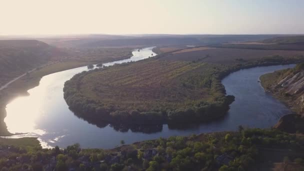 Vuelo sobre el río y el pequeño pueblo en otoño. República de Moldavia. Pueblo Molovata. Río Dniéster. — Vídeos de Stock