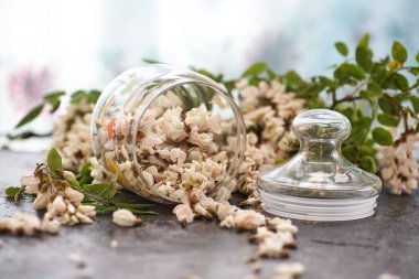 Akasya çiçekleri cam kasede masanın üstünde.