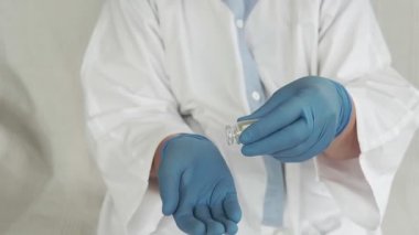 Haplar doktorun elindedir. Tıbbi eldivenlerdeki eller hapları tutsun. Hastalık için ilaç.