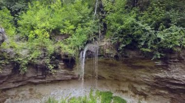 Yeşil ormanda smalll şelale üzerinde uçuş. Drone 4k 30fps ile çekildi