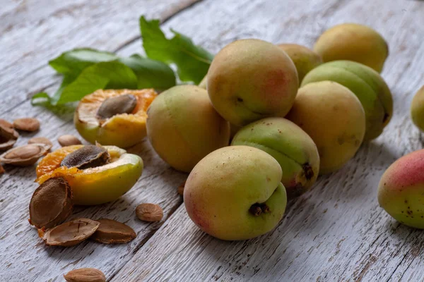 Apricot fruit. Fresh organic apricots on a white wooden background. Vega food.