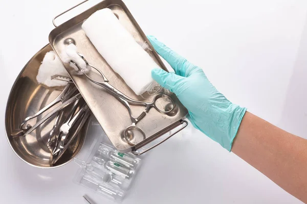 Dental appliances in sterile packaging. Dentists hand in gloves