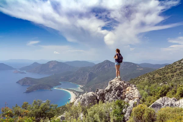 Hiker girl on the mountain top. Sport and active life concept. Oludeniz, Turkey