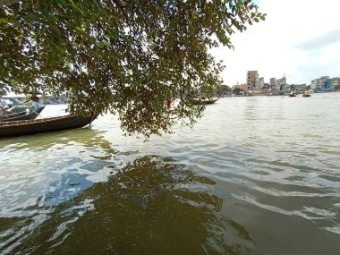 Nehirde siyah renkli ahşap balıkçı teknesi