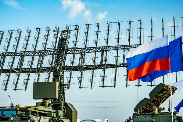 Air defense radars of military mobile antiaircraft systems, modern army industry on background blue sky. Flag of Russia