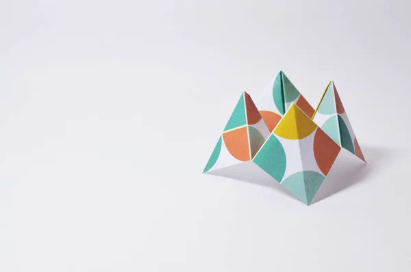Origami figure paper in white background, ideal for your education projects or origami topics in your publications.