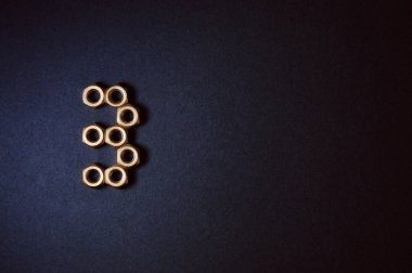 Şekiller ve numaraları koyu arka planda oluşturan altın mekanik fındık