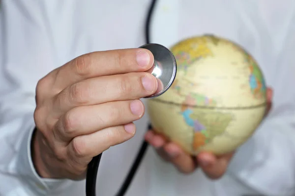 Elinde stetoskop ve küre olan doktor. Abd, Kuzey ve Güney Amerika'da tıbbi ağ ve sağlık hizmetleri, dünya tıbbı kavramı, uluslararası Sağlık Çalışanları Günü