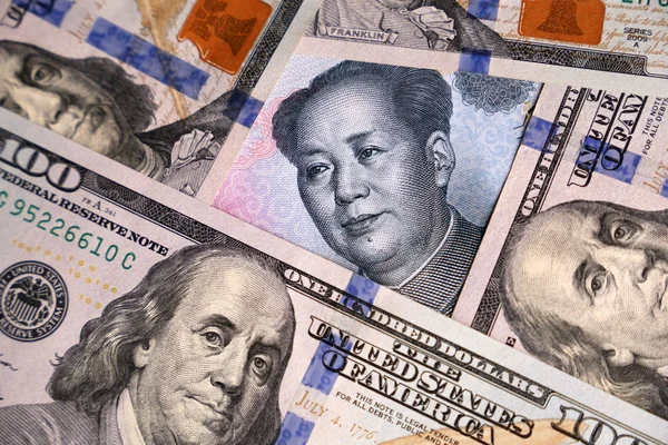 US dollars and chinese yuan banknote. Concept of trade war between the China and USA, economic, sanctions, tourism and investment