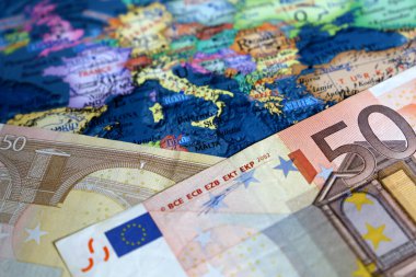 Euro banknotes on the map of Europe. Concept for european economy, eurozone countries clipart