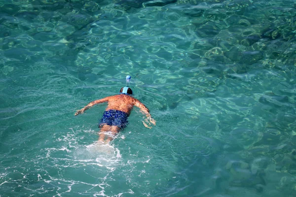 海でのシュノーケリング ビーチ休暇 マスクの男は澄んだ青い水の中で トップビュー泳ぐ — ストック写真