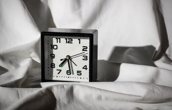 Black Alarm Clock White Sheet Hard Shadows Sleeping — Stock Photo, Image