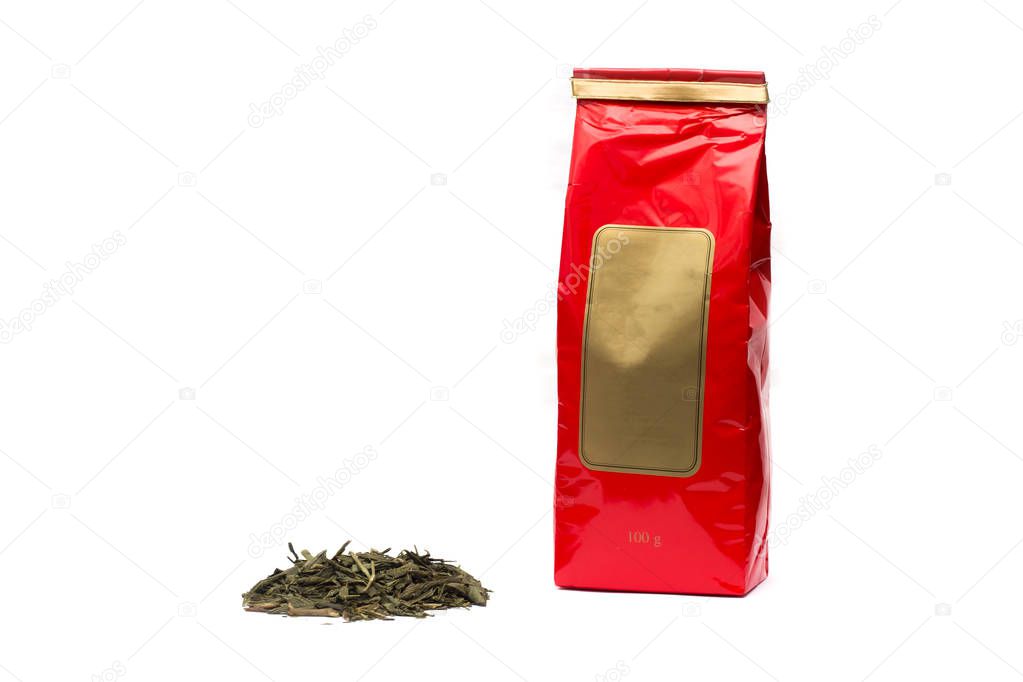 Pile of tea leaves and green tea packing on white background, isolate