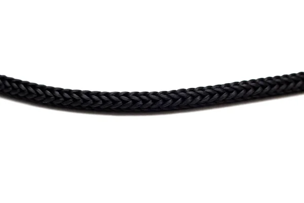 Cuerda negra de cerca sobre un fondo blanco — Foto de Stock