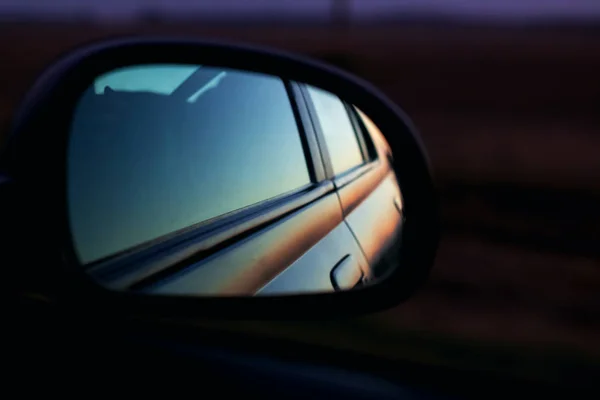 Car mirror at sunset in the dark with copy space