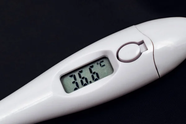 White electronic thermometer close up, temperature is normal, copy space