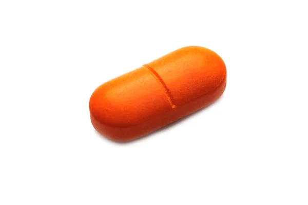 Une Pilule Orange Près Isoler Sur Fond Blanc — Photo