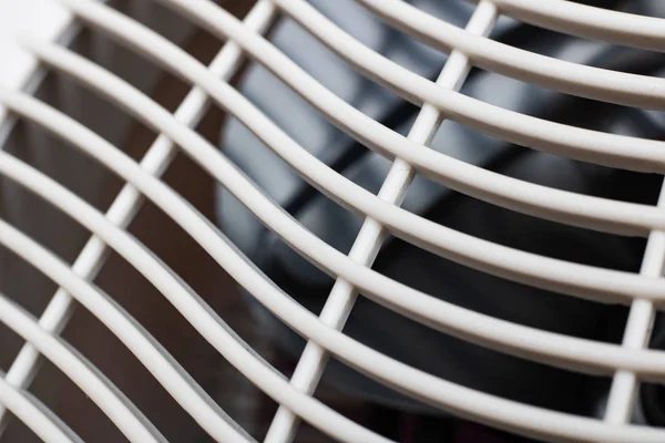 White plastic grill on the fan close up, macro photo