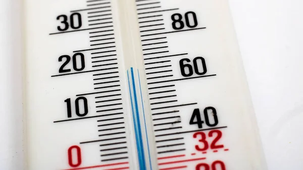 Room mercury thermometer on a white background close up, macro